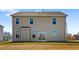 Back exterior featuring a yard and neutral siding, with a sliding glass door at 2820 Lacy Holt Rd, Graham, NC 27253