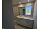 Modern bathroom featuring glass shower, white vanity with quartz countertop, and large mirror at 1341 Bessie Ct, Wake Forest, NC 27587