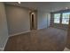 Bedroom with neutral carpet, two windows, and an en-suite bathroom at 1341 Bessie Ct, Wake Forest, NC 27587
