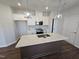 Kitchen featuring a central island with stainless steel appliances, a white countertop and dark wood cabinets at 1341 Bessie Ct, Wake Forest, NC 27587