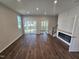 Bright living room with fireplace, hardwood flooring, recessed lighting, and glass doors to screened in porch at 1341 Bessie Ct, Wake Forest, NC 27587