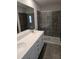 Bathroom featuring double sinks, gray tile flooring and a glass enclosed tile shower at 1343 Bessie Ct, Wake Forest, NC 27587