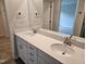 Bathroom with double sink vanity, quartz countertop, and large mirror at 1343 Bessie Ct, Wake Forest, NC 27587