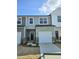 New construction two-story townhome featuring a one car garage and stylish exterior in neutral colors at 1343 Bessie Ct, Wake Forest, NC 27587
