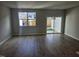 Light-filled living room featuring wood-look flooring and sliding glass doors to the outdoor space at 1343 Bessie Ct, Wake Forest, NC 27587