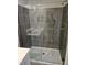 Modern shower with gray tile surround, glass doors and built-in niche at 1343 Bessie Ct, Wake Forest, NC 27587
