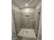 Bathroom featuring a large glass shower with gray tile surround and recessed niche at 1345 Bessie Ct, Wake Forest, NC 27587