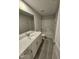 Modern bathroom with white vanity, large mirror, and shower-tub combo at 1345 Bessie Ct, Wake Forest, NC 27587