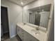 Bathroom with double sink vanity, quartz countertop and an oversized mirror at 1345 Bessie Ct, Wake Forest, NC 27587
