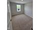 This carpeted bedroom is brightened by a window at 1345 Bessie Ct, Wake Forest, NC 27587