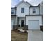 Charming townhome with attached garage, neutral siding, and inviting entryway at 1345 Bessie Ct, Wake Forest, NC 27587