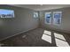 Sun-filled bedroom with neutral carpet, multiple windows, and calming gray walls at 1349 Bessie Ct, Wake Forest, NC 27587