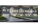 Attractive townhomes with garages, neutral color schemes, and landscaping at 1349 Bessie Ct, Wake Forest, NC 27587
