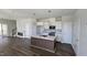 Open-concept kitchen featuring a center island, white cabinets, and stainless steel appliances at 1349 Bessie Ct, Wake Forest, NC 27587