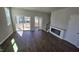 Bright living room with dark floors, sliding glass doors, and modern fireplace at 1349 Bessie Ct, Wake Forest, NC 27587