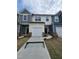 Charming townhome featuring an attached garage and beautifully landscaped front yard at 1351 Bessie Ct, Wake Forest, NC 27587