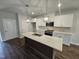 Modern kitchen with island, stainless steel appliances, and pendant lighting at 1351 Bessie Ct, Wake Forest, NC 27587