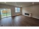 Bright living room with an electric fireplace and sliding glass door to the backyard at 1351 Bessie Ct, Wake Forest, NC 27587