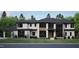 Striking modern home featuring stone and cement exterior with black framed windows at 4908 Foxridge Dr, Raleigh, NC 27614