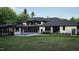 Luxury rear exterior featuring covered patio, large windows, and swimming pool at 4908 Foxridge Dr, Raleigh, NC 27614