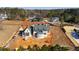 Aerial view of new traditional style home with gray brick, black trim, gray shake roof on an unfinished lot at 705 Parker Creek Dr, Raleigh, NC 27614