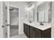 Bathroom with double vanity, dark brown cabinets and marble floor at 119 Water Ave, Wake Forest, NC 27587