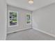 Bright bedroom with carpet flooring and two large windows at 119 Water Ave, Wake Forest, NC 27587