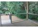 Wooden deck with black metal railings overlooking wooded area at 119 Water Ave, Wake Forest, NC 27587