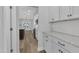 Hallway leading to open kitchen and living space; features granite counters and subway tile backsplash at 119 Water Ave, Wake Forest, NC 27587