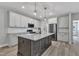Bright kitchen featuring granite countertops, stainless steel appliances, and a functional center island at 119 Water Ave, Wake Forest, NC 27587