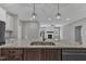 Kitchen island featuring a stainless sink with views into the living room and fireplace at 119 Water Ave, Wake Forest, NC 27587