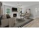 Inviting living room featuring a cozy fireplace, stylish decor, and hardwood flooring at 119 Water Ave, Wake Forest, NC 27587