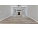 A bright and spacious living room showcasing a fireplace, wood-look flooring and large windows at 119 Water Ave, Wake Forest, NC 27587