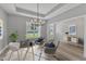 Bright office space with a modern chandelier, comfortable seating, and plenty of natural light at 119 Water Ave, Wake Forest, NC 27587