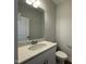Elegant half bath with granite countertop, modern sink, and toilet, offering a clean and stylish design at 484 Traditions Grande Blvd # 29, Wake Forest, NC 27587