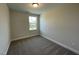 Bright bedroom features neutral paint, plush carpet and natural light from the window at 484 Traditions Grande Blvd # 29, Wake Forest, NC 27587