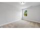 Clean and bright bedroom with neutral carpet and a single window at 484 Traditions Grande Blvd # 29, Wake Forest, NC 27587