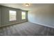 Spacious bedroom featuring neutral paint, plush carpet and natural light from two windows at 484 Traditions Grande Blvd # 29, Wake Forest, NC 27587