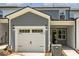 View of home exterior with white garage door and gray siding at 484 Traditions Grande Blvd # 29, Wake Forest, NC 27587