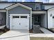 Charming exterior of a gray and white townhome with a single-car garage and manicured lawn at 484 Traditions Grande Blvd # 29, Wake Forest, NC 27587