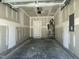 Interior view of the garage with water heater, door, and bare walls at 484 Traditions Grande Blvd # 29, Wake Forest, NC 27587