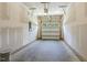 Unfinished garage featuring white door with windows and concrete floor at 484 Traditions Grande Blvd # 29, Wake Forest, NC 27587
