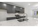 Beautiful kitchen features a speckled white countertop, stainless steel appliances, and modern gray cabinetry at 484 Traditions Grande Blvd # 29, Wake Forest, NC 27587