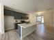 Modern kitchen with gray cabinets, a large island, and stainless steel appliances, creating an inviting space at 484 Traditions Grande Blvd # 29, Wake Forest, NC 27587