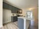 Modern kitchen with gray cabinets, a large island, and stainless steel appliances, perfect for cooking at 484 Traditions Grande Blvd # 29, Wake Forest, NC 27587