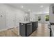 Open kitchen with a gray island, granite countertops, stainless steel appliances, and an adjoining living room at 484 Traditions Grande Blvd # 29, Wake Forest, NC 27587