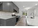 Spacious kitchen with granite countertops, modern appliances, gray cabinets, and an open view to the dining area at 484 Traditions Grande Blvd # 29, Wake Forest, NC 27587