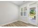 Bright living room with fresh paint, a window, an entrance door, and backyard views at 484 Traditions Grande Blvd # 29, Wake Forest, NC 27587