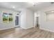 Living room with wood-look flooring, fresh paint, a back door, and a view of the neighborhood at 484 Traditions Grande Blvd # 29, Wake Forest, NC 27587