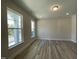 Bright living room with luxury vinyl plank flooring and large windows providing natural light and street views at 484 Traditions Grande Blvd # 29, Wake Forest, NC 27587